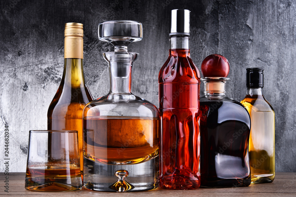 Carafe and bottles of assorted alcoholic beverages. - obrazy, fototapety, plakaty 