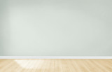 Fototapeta Tęcza - Light green wall in an empty room with a wooden floor