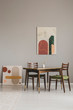 © Photographee.eu - Abstract paintings on grey wall of retro dining room interior
