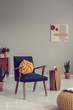 © Photographee.eu - Knot pillow on vintage armchair in grey living room interior