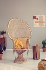 Wall Mural - Wicker peacock chair with pillows in retro living room interior