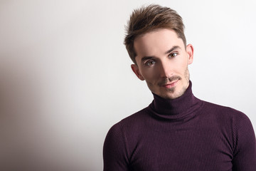 Handsome young elegant man in violet golf.