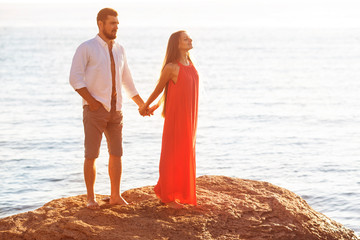 man and woman stand on the stone