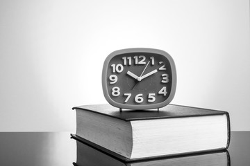 Wall Mural - Clock and book with yellow background