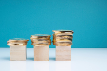 Cube wooden and coins stacking woth financial concept.