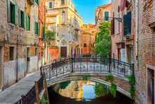 Narrow Canal With Bridge In Venice, Italy. Architecture And Landmark Of Venice. Cozy Cityscape Of Venice.