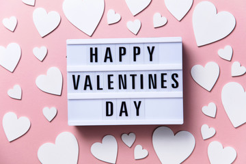 Wall Mural - Happy Valentin's Day lightbox message with white hearts on a pink background