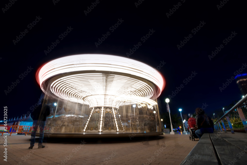 Abstract, long exposure shot of spinning Children's vintage Carousel at ...
