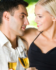 Young happy couple with champagne, outdoor