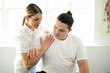 © Louis-Paul Photo - A Modern rehabilitation physiotherapy woman worker with client