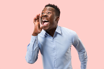 Do not miss. Young casual man shouting. Shout. Crying emotional man screaming on pink studio background. male half-length portrait. Human emotions, facial expression concept. Trendy colors