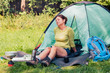 © Przemek Klos - Spending a vacation on camping. Woman resting next to tent