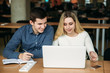 © Aleksandr - Boy and girl sits in universiti library. They use laptop to prepare for an exam. Study