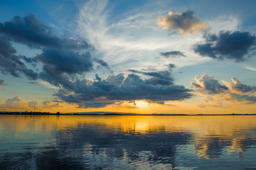 Wall Mural - sunset sky with clouds above lake, tourist attraction nong han lake at sakon nakhon province in thai