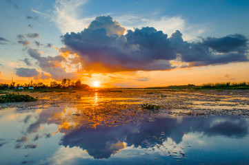 Wall Mural - sunset sky with clouds above lake, tourist attraction nong han lake at sakon nakhon province in thai