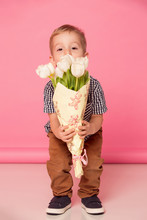 Cute Baby Gives A Bouquet Of White Tulips
