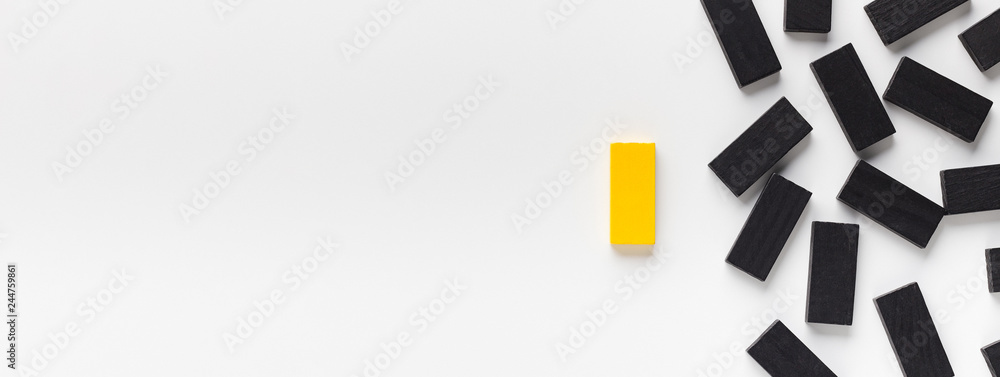Yellow block standing out of black ones - obrazy, fototapety, plakaty 