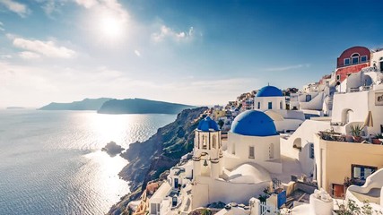 Fototapete - Architecture of Oia village, Santorini island in Greece, on a sunny day with dramatic sky. 4K timelapse. 
