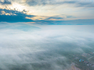 Wall Mural - Aerial view of mountain and morning mist during sunrise.