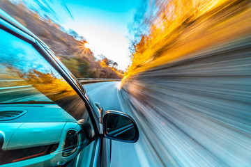 Wall Mural - Car in motion blur driving in the Mountains