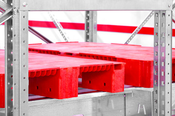 Fototapete - Empty red plastic pallets on racks in an automated warehouse complex