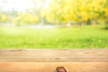 Wall Mural - Real wood table top texture on leaf tree garden background