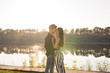 © satura_ - Romantica, nature and people concept - young couple kissing on the beach of lake and hugging