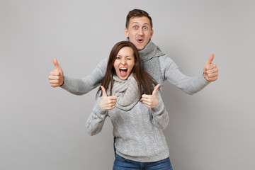 Wall Mural - Young cute couple girl guy in gray sweaters, scarves together isolated on grey wall background, studio portrait. Healthy lifestyle, ill sick disease treatment, cold season concept. Mock up copy space.