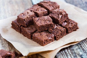 Wall Mural - Pieces of freshly baked chocolate brownie on rustic wooden board