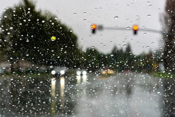 cars driving through rain; raindrops on the windshield