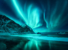 Amazing Aurora Borealis. Northern Lights In Lofoten Islands, Norway. Starry Sky With Polar Lights. Night Winter Landscape With Aurora, Sea With Frosty Coast And Sky Reflection, Snowy Mountains. Travel