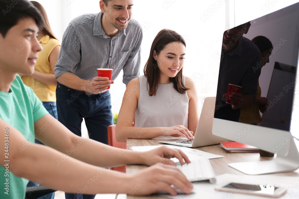 Young team working with marketing plan in office