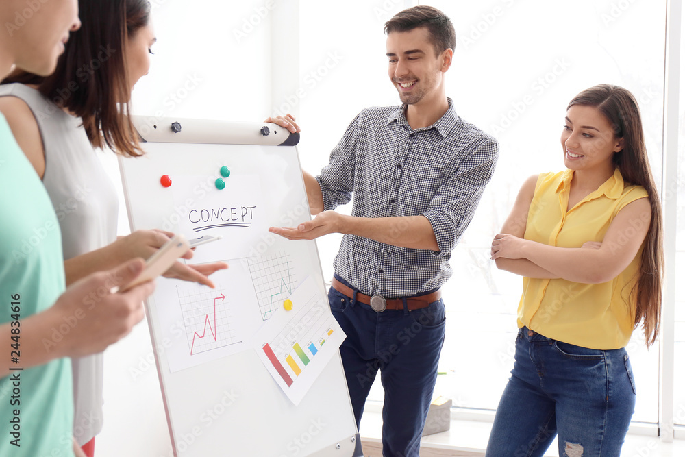 Young team working with marketing plan in office