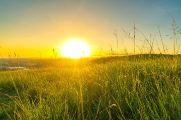 Wall Mural - Green hill with sunrise background
