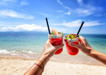 Fresh Watermelon Juice With A Straw In Two Glasses Against A Bright Tropical Landscape, Against The Background Of The Sea. Vacation Vacations Healthy Food Concept