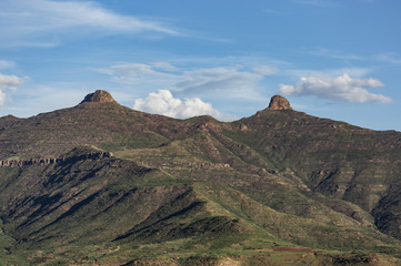 Landscape of two tits mountain at Lesotho country in Africa. Blue sky and white clouds in a midday. Landmark view.