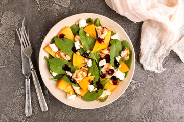 Wall Mural - Exotic salad with spinach, persimmon, grilled chicken fillet, feta