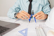 © PhotoJuthamat - Concept architects,engineer holding Circus pointing equipment architects On the desk with a blueprint in the office Vintage Sunset light.Selective Focus