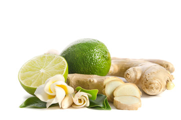 Ginger root and lime whole and half with flowers and leaves isolated on white background