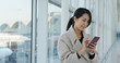 © leungchopan - Woman use of mobile phone in the airport