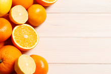 Ripe Fruit On A White Wooden Background. Ripe Oranges, Lemons And Tangerines. Vitamin C. Place For Text. Top View.