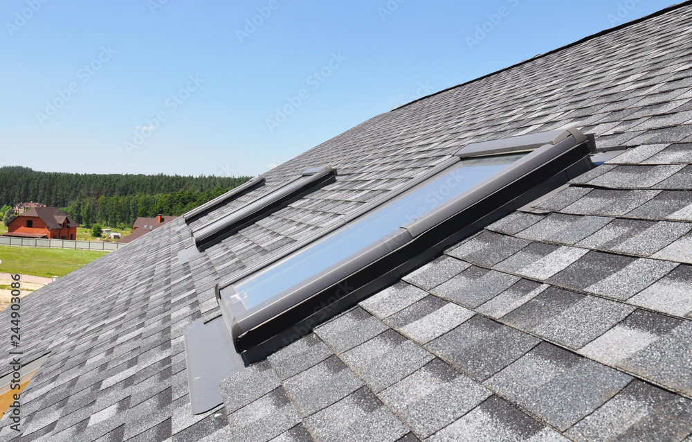 Skylights windows on modern house roof top. Attic skylight windows on ...
