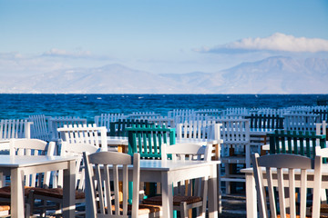 Wall Mural - restaurant chairs and tables by the sea