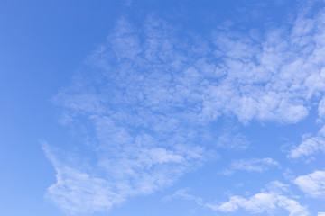 Blue sky background with white clouds, rain clouds on sunny summer or spring day.