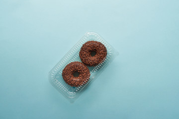 top view of tasty chocolate donuts on blue background