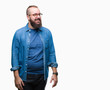 © Krakenimages.com - Young caucasian hipster man wearing glasses over isolated background looking away to side with smile on face, natural expression. Laughing confident.