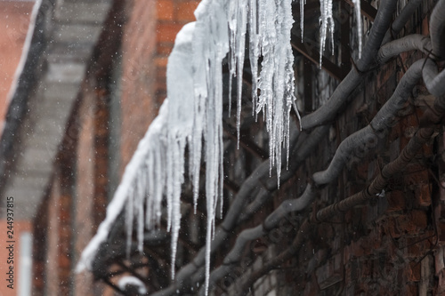 Sharp Icicles Hanging From Roof Of The Building Snow In The Background Fall Icicles Sold Winter Poor Thermal Insulation Ice Stalactite Formation Of Icicles Frost And Winter Weather Concept Stock Photo Adobe