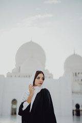 Wall Mural - Female tourist visiting at Sheikh Zayed Grand Mosque in Abu Dhabi