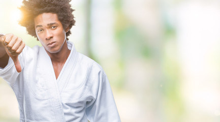 Canvas Print - Afro american man wearing karate kimono over isolated background looking unhappy and angry showing rejection and negative with thumbs down gesture. Bad expression.