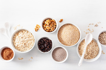 Wall Mural - variaty of raw cereals and nuts for breakfast. Oatmeal flakes and steel cut, barley, walnut, chia, raisins. Healthy ingredients